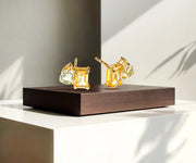 Gold Toi et Moi stud earrings with two gemstones.